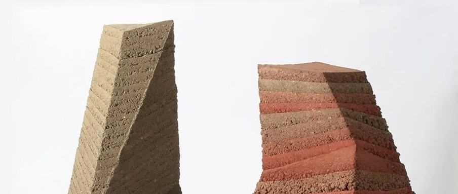 Two geometric rammed earth sculptures